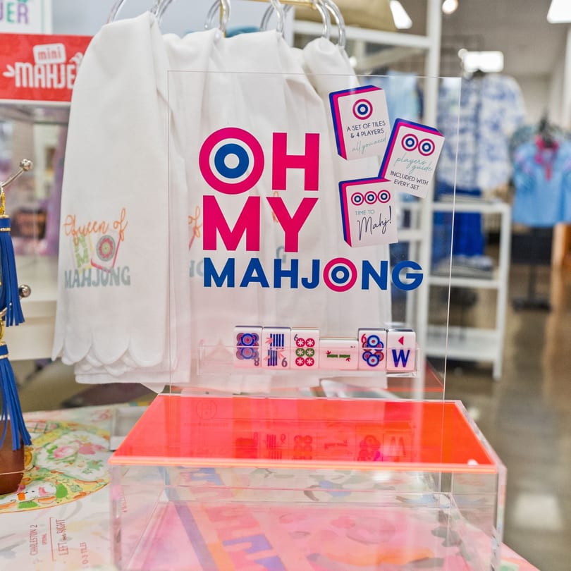 A clear acrylic display with "OH MY MAHJONG" in pink and blue, showcasing Mahjong tiles.